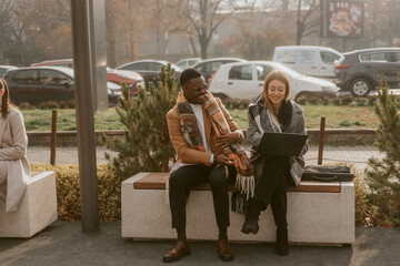 Wall Mural - Two business colleagues smiling while sitting