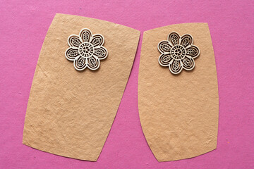 two textured paper cards each with a floral object