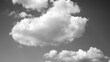 blue sky with numerous clouds with sun filtering from behind on a sunny day (black and white)