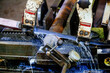 © Mulderphoto - Automatic band saw machine with the liquid coolant is cutting metal rod, close up