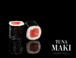 Close up to Maki sushi roll pieces with mirror reflection on black background. Sushi roll with tuna Maguro and nori seaweed on top. Ready menu advertising banner with text and copy space.