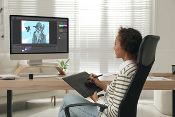 African American animator using graphic tablet and computer. Illustration on screen