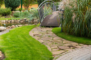 Wall Mural - Walking path made of natural stone walks in landscape design