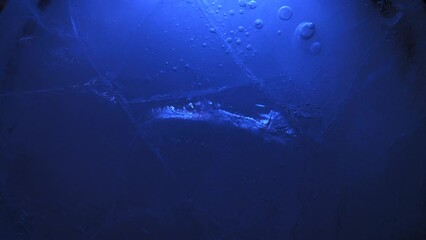 Wall Mural - Abstract ice background. Blue background with cracks on the ice surface.