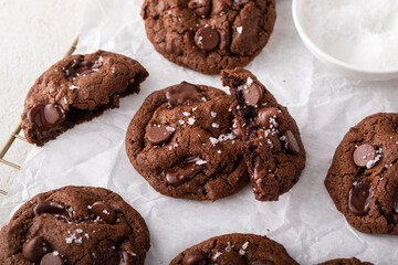 Double chocolate cookies with flaky salt on a cooling rack