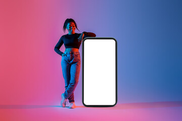 Poster - Mobile offer. Black lady leaning on big smartphone with blank screen, recommending app or website, mockup, neon light