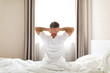 © Prostock-studio - Well-rested middle aged man sitting on bed at home