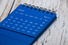 August 2023 Blue Table Calendar On Wooden Cover Background. Calendar Concept.