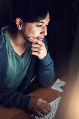 Poster - Web designer, Asian man at desk and thinking during night shift, overtime and deadline at digital marketing agency. Content research, reading and serious male, working late at startup and typing