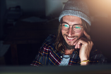 Poster - Internet, laptop and man streaming online video at night or evening with a smile reading an email, website or web. Person, young and male browsing using wifi on a computer and working late