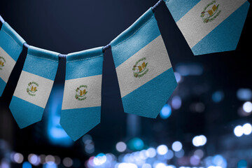 Sticker - A garland of Guatemala national flags on an abstract blurred background