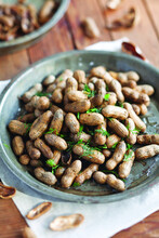 Close-up of boiled peanuts garnished in plate on table at home