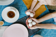 Food Photo Easter On Table. White Eggs In Hands. Mother With Daughter