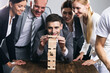 Business people building wood tower