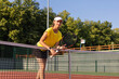 © ty - Pretty sportswoman with racquet at the tennis court. Healthy lifestyle.