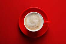 Cup With Aromatic Cappuccino On Red Background, Top View