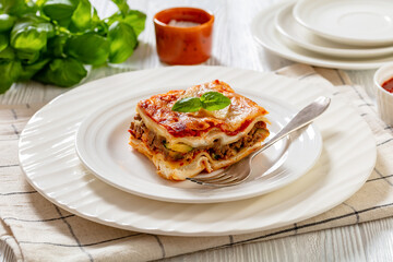 Sticker - portion of Lasagna on white plate, top view