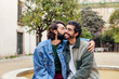 © Raul Mellado - young man kissing tenderly his boyfriend's cheek, concept of urban lifestyle and love between people of the same sex, copy space for text