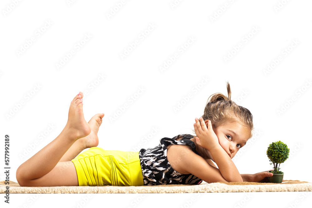 cute litthe girl lying on the ground and playing with tiny little toy ...