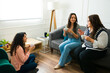 © AntonioDiaz - Female friends enjoying a cup of coffee together at home and having some fun