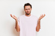 © South House Studio - Young caucasian sad man with serious face feeling miserable and displeased keeps hands aside isolated over white background