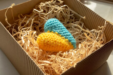 Gift - The Heart Of The Colors Of The Flag Of Ukraine. The Symbol Of Ukraine Is A Yellow-blue Heart In A Gift Box In Tinsel. Knitted Heart Of Yellow And Blue Flowers In A Gift Box.