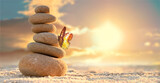 Fototapeta Desenie - Stone tower. Natural pebble stone on the beach. Balancing body, mind, soul and spirit. Mental health.