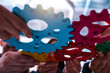 © alphaspirit - Teamwork of business people work together and combine pieces of gears