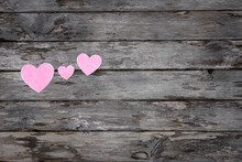 Three Pink Hearts On Wooden Background. Family And Love Concept