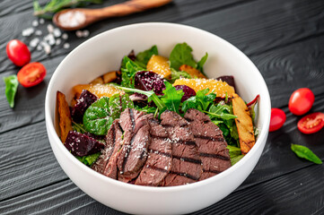 Wall Mural - Salad with roast beef and caramelized beets with orange fillet, potatoes, parmesan, salad mix and olive oil