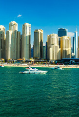Wall Mural - postcard view of modern Dubai with expensive luxury yachts, the sea and modern architecture