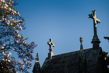 the crosses of the ancient crypt against the blue sky.