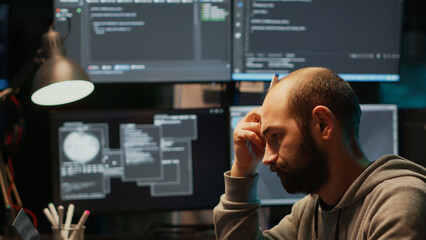 thoughtful it engineer brainstorming ideas in office, programming script and source code. pensive ma