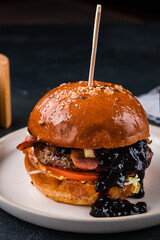 Wall Mural - American burger with beef, pork, tomatoes, cabbage, blue cheese and blackcurrant jam.