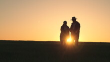 Agriculture. Group People Work Sunset Wheat Field. Teamwork Silhouette. Farming Concept. Farmer Works Tablet With Business Partner Field. Team People Meeting. Agriculture Concept. Smart Farm Wheat
