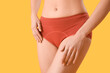 © Pixel-Shot - Young woman in menstrual panties on yellow background, closeup