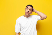 Young Pensive Guy Afro American Confused Scratches His Head And Remembers On Yellow Isolated Background