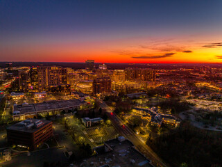 Colorful red, orange, yellow sunset sky over Reston town business center in Virginia