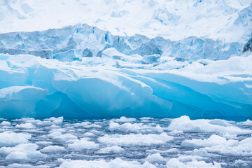 View of icebergs, sea ice, and glacier ice in Antarctica