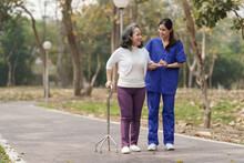Healthcare Nurse, Physical Therapy With Elderly Woman At Outdoor. Nurse Holding Hand And Help Elderly Woman Walking