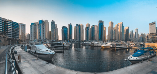 Wall Mural - Dubai Marina, harbour, cruise boat and canal promenade view at sunset, in Dubai, United Arab Emirates