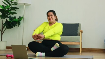 Wall Mural - Asian fat woman exercising at home for health and fitness exercise to lose fat burn fat by sitting and stretching and loosening your arm muscles, straight arms, straight body : Health care concept.
