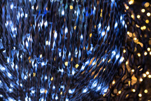 Beautiful Defocused Background With Blue And Golden Christmas Illumination At Night. Decoration Close Up On The Streets At Night During Holidays