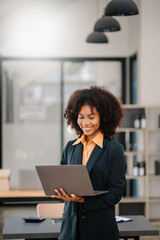 Secretary working in modern office in skyscraper, writing and sticking adhesive notes with tasks on window modern office.