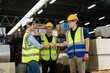 © Jirus - Asian warehouse workers team shaking hands together in the storage warehouse, feeling happy and smiling. teamwork at warehouse storage department.