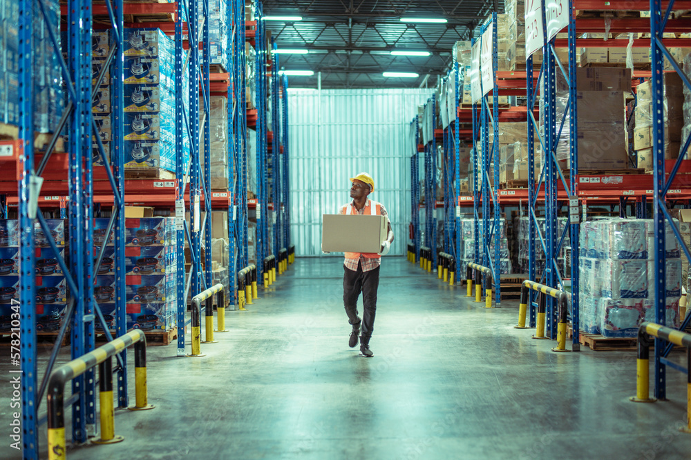African American male warehouse worker hold cardboard box packaging in ...