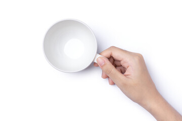 Female hand holding empty coffee cup isolated on white background with clipping path, top view, flat lay.