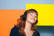 © Jacob Lund - Carefree woman listening to relaxing music with geometric shapes in the background