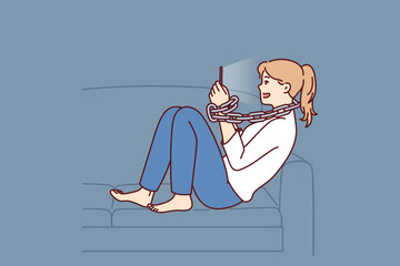 Canvas Print - Young woman addicted to mobile phone sitting on sofa with chain around neck. Introverted girl procrastinates using gadgets and suffers from addicted causing loneliness and lack of friends 