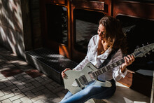 Beautiful Woman Plays Guitar In Town